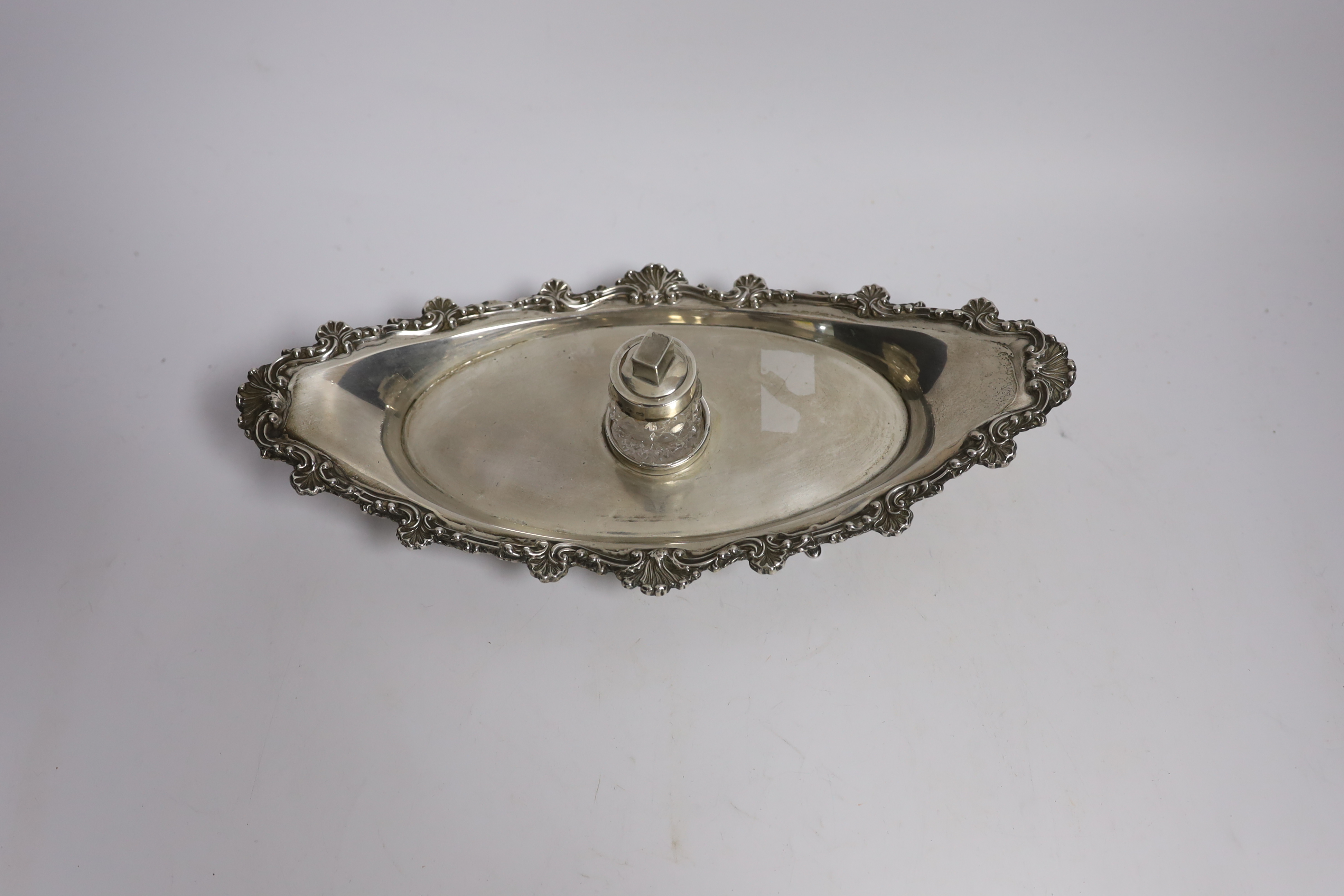 A late Victorian silver navette shaped inkstand, with silver mounted cut glass well, on four reeded feet, William Mammatt & Son, Sheffield, 1898, 27.7cm, 9.4oz.